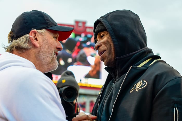 Nov 25, 2023; Salt Lake City, Utah, USA; Colorado Buffaloes head coach Deion 'Coach Prime' Sanders congratulates Utah Utes head coach Kyle Whittingham after the Utah Utes victory over the Colorado Buffaloes at Rice-Eccles Stadium. Mandatory Credit: Christopher Creveling-USA TODAY Sports